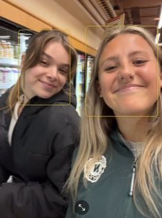 two girls are smiling and looking at the camera with different facial expressions on their faces