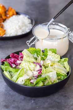 a salad with dressing being poured into it