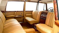 the interior of a car with tan leather seats and wood trimmings on it