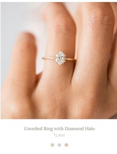 a woman's hand with a diamond ring on her finger and the words, unveiled king with diamond halo