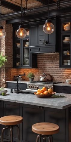 a kitchen with black cabinets and wooden stools in front of an island topped with fruit