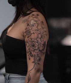 a woman with a flower tattoo on her arm