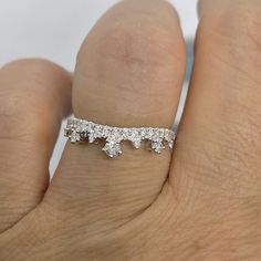 Beautiful Crown Diamond Band White Gold. This regal Diamond band is great to wear on its own or stack with another ring. The diamonds are very sparkling. *engagement ring shown in picture is sold separately. Genuine Round Brilliant Cut Diamonds Total Weight: 0.35 Carats Clarity: SI 1 Color: G Solid 18K White Gold Stock ring size 6.5 Comes with gift box Luxury Silver Moissanite Stackable Rings, Luxury Diamond Stackable Rings With Diamond Cut, Luxury Stackable Rings With Round Cut Cubic Zirconia, Diamond Stackable Rings With Vvs Clarity And Open Band, Stackable Diamond Rings With Vvs Clarity, Stackable Diamond Rings With Vvs Clarity And Open Band, Luxury Cubic Zirconia Stackable Rings With Round Cut, Luxury Stackable Cubic Zirconia Rings With Round Cut, Dazzling Diamond Stackable Rings For Anniversary