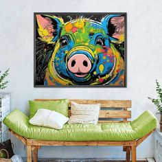 a painting of a pig on a wall above a bench in a room with green pillows