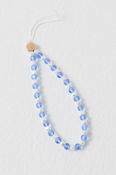 a blue beaded necklace on a white background