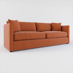 an orange couch with two pillows on the back and one arm folded out to show it's shape