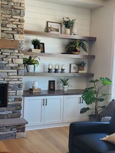 a living room filled with furniture and a fire place in front of a stone fireplace