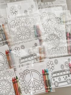 several coloring books and crayons in plastic bags with flowers, cars, and peace signs on them