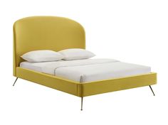 a yellow bed with white pillows on top of it and a metal frame around the headboard