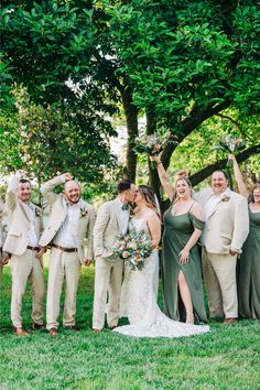 a group of people standing next to each other on top of a lush green field