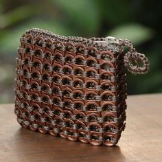 a brown purse sitting on top of a wooden table