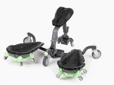 three miniature tricycles with wheels and seats on them, all in black and green