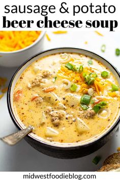 a bowl of soup with cheese and green onions in it next to a plate of bread