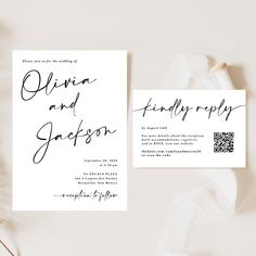 the wedding stationery is laid out on top of white paper and has black ink