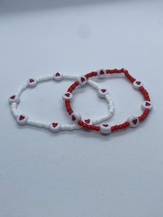 two red and white beaded bracelets with hearts