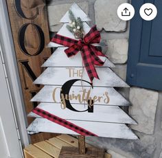 a christmas tree made out of pallet wood with the letter c painted on it