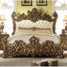 an ornate gold bed with white linens and pillows