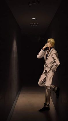 a man in a suit and tie standing in a dark hallway with his hand on his face