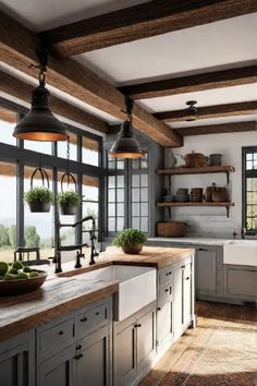 a large kitchen with lots of counter space and hanging lights above the sink, along with open shelving