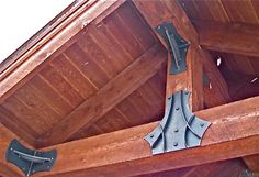 an image of a wooden structure with metal brackets on the side and wood beams above it