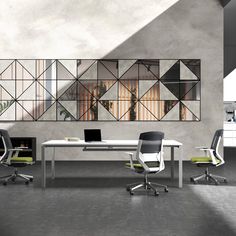 an office area with two desks, chairs and a large mirror on the wall