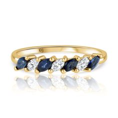 a yellow gold ring with blue and white stones