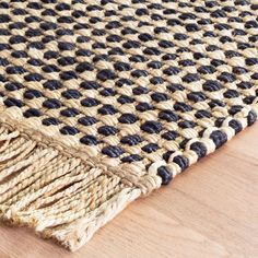 a close up of a rug on a wooden floor