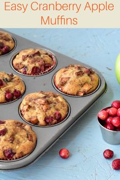 cranberry apple muffins in a muffin tin on a blue table