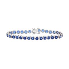 "Lab-created sapphire gemstones give this sterling silver tennis bracelet alluring appeal.BRACELET DETAILS Length: 7.25 in. Clasp: box Metal: rhodium-plated sterling silver STONE DETAILS Stone type: lab-created sapphire Total weight: 8 1/2 ct. Shape: round Setting: bezel  Size: 7.25"". Color: Blue. Gender: female. Age Group: adult." Sapphire Cubic Zirconia Tennis Bracelet With Gemstone, Sapphire Tennis Bracelet Fine Jewelry With Prong Setting, Silver Sapphire Tennis Bracelet With Brilliant Cut, Silver Sapphire Tennis Bracelet, White Gold Sapphire Gemstone Tennis Bracelet, Sapphire Tennis Bracelet With 17 Jewels, Classic Blue Diamond Bracelet In Sterling Silver, Blue Sapphire Tennis Bracelet With Gemstone, Sapphire Gemstone Tennis Bracelet In Fine Jewelry Style