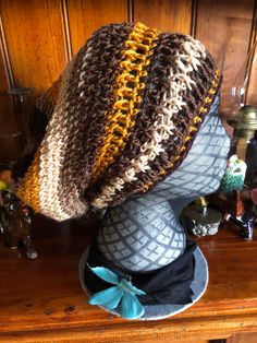 a crocheted hat is sitting on top of a mannequin's head