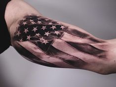 a man's arm with an american flag tattoo on it