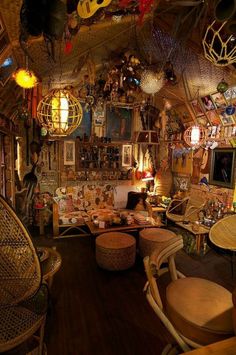 a room filled with lots of wicker furniture and hanging decorations on the ceiling above it