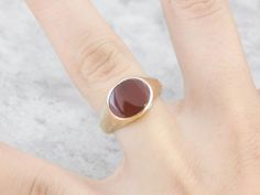 This beautiful antique mounting is crafted of rose gold, a warm color created by alloying with copper. This beautiful styled ring could be for a man or a woman, and has simple engraving on the sides and a warm rich Carnelian center. Carnelian is the reddish-orange version of Chalcedony, and can either be uniformly colored or have visible bands through the stone. Metal: 14K Yellow Gold Gem: Carnelian Gem Measurements: 9.2 x 12 mm, Curved Cut Oval Ring Size: 7.25 Marks: "14" Stamped on the inside Rose Gold Signet Ring With Gemstone, Rose Gold Gemstone Signet Ring, Rose Gold 14k Gemstone Signet Ring, Classic Brown Rings With Polished Finish, Classic Oval Brown Ring, Classic 14k Gold Brown Ring, Classic Brown Oval Ring, Elegant Brown Signet Ring For Anniversary, Classic Brown Signet Ring For Anniversary