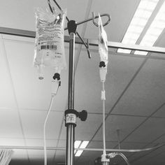 an iv device is attached to a pole in a room with light coming from the ceiling