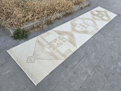 a large white rug sitting on top of a sidewalk