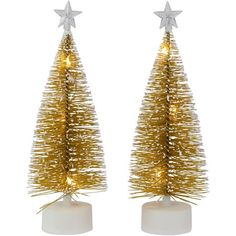 two small christmas trees with gold tinsels and stars on the top, sitting side by side