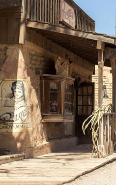 an old western building with a sign on the front and side of it that says candy james