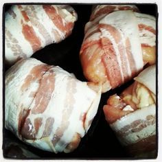 several pieces of bread wrapped in bacon sitting on top of each other