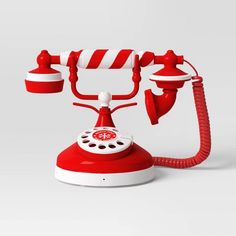 an old fashioned red and white telephone