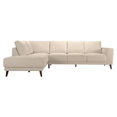 a white sectional couch sitting on top of a wooden floor