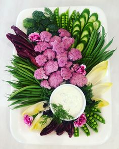 a platter with broccoli, cauliflower and other vegetables on it