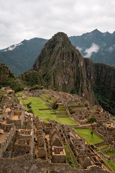 an aerial view of the ancient city of machalucca, with mountains in the background