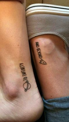 two people with matching tattoos on their legs, one is holding the other's leg