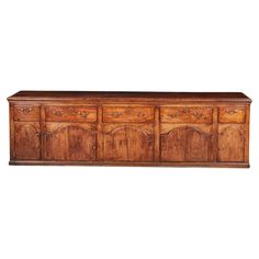 an old wooden sideboard with many drawers