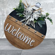 the welcome sign is made out of wood and metal