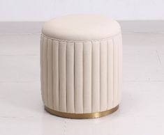 a white stool sitting on top of a tile floor