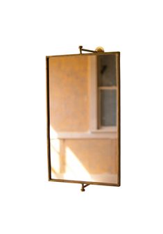 the reflection of a bathroom sink and mirror in a wall mounted medicine cabinet with brass faucet