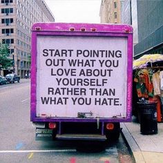 a sign on the back of a truck that says start pointing out what you love about yourself rather than what you hate