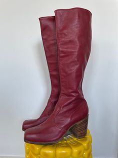 "ITEMS PURCHASED BETWEEN 11/20-1130 WILL SHIP 12/1  Andy from JJ Flash would fly to England and have these boots custom made.  As is, no returns. See full description and images. Description:  Iconic early 1970s boots. Deep red leather throughout, and lined in solid brown leather. Interior zipper and wooden stacked block heel with a square toe. Printed inside is the iconic JJ Flash label, \"Made in England\" printed below it.  Damage notes: Wear consistent with age. Really great condition. Some Red Boots Vintage, Red Leather Knee High Boots, Retro Fall Boots With Stacked Heel, Retro Boots With Stacked Heel For Fall, Retro Stacked Heel Boots For Fall, Vintage Boots With Leather Sole And Square Toe, Retro Wide Calf Knee-high Boots, Retro Leather Boots With Square Toe, Retro Square Toe Leather Boots