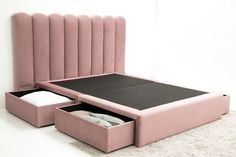 a pink bed with two drawers on the bottom and an open drawer in the middle